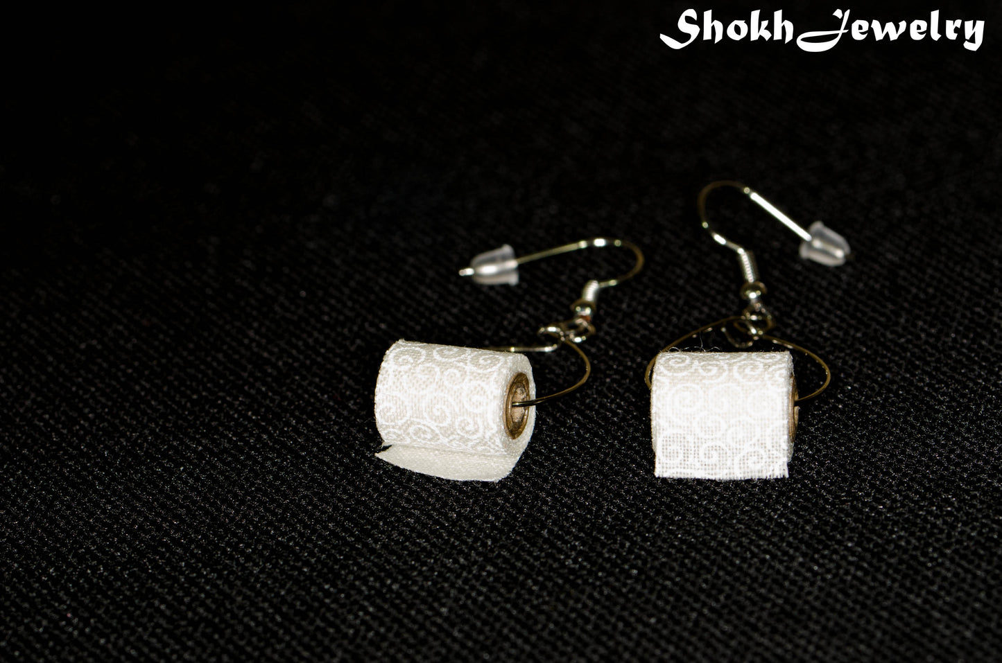 Close up of Miniature Toilet Paper Roll Earrings.