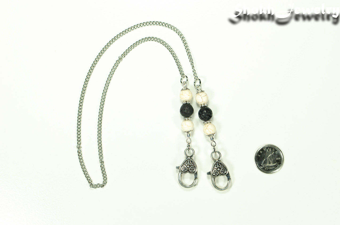 8mm White Howlite and Black Lava Stone Eyeglass Chain beside a dime.