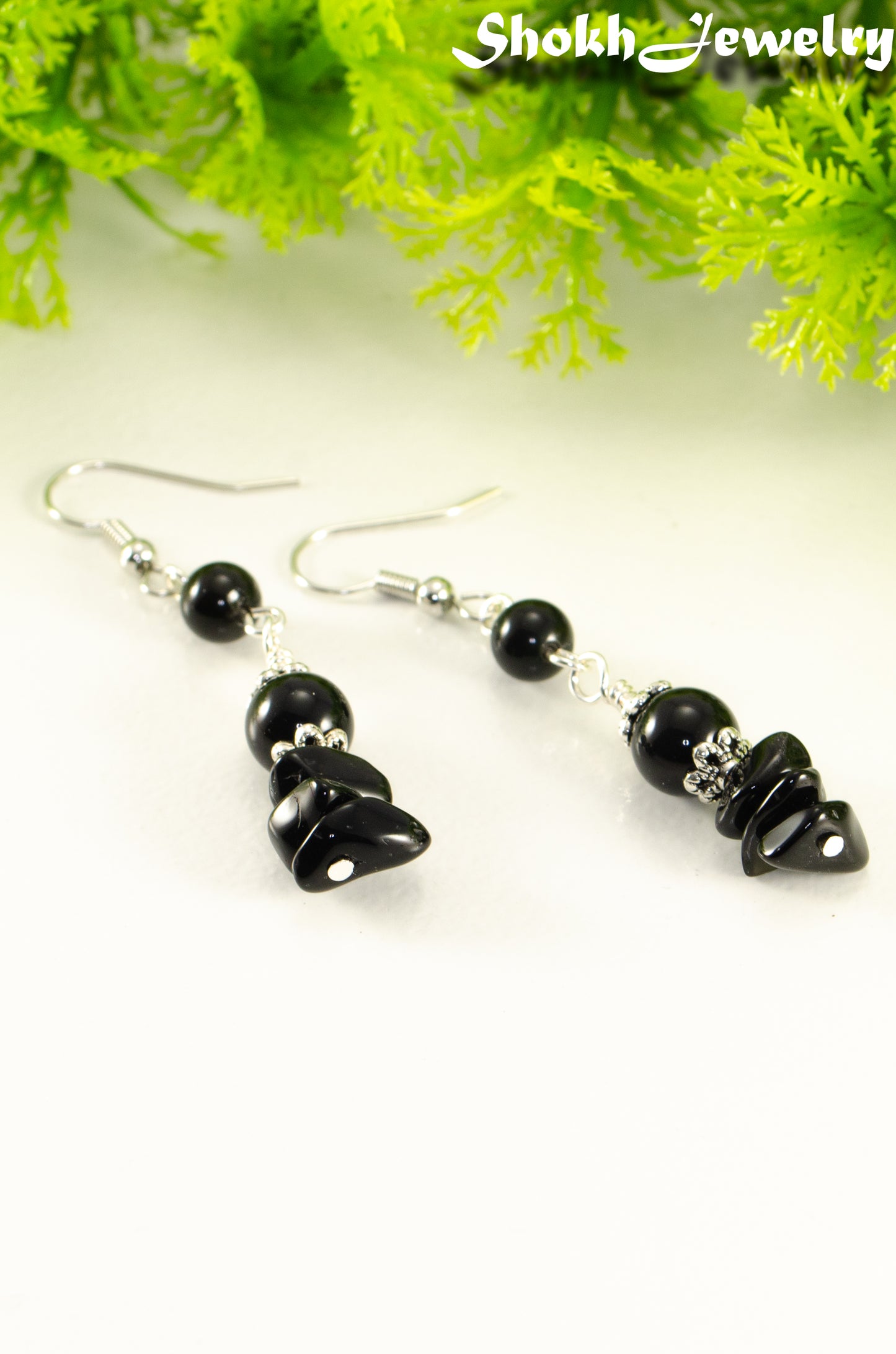 Close up of Long Black Obsidian Crystal Chip Earrings.