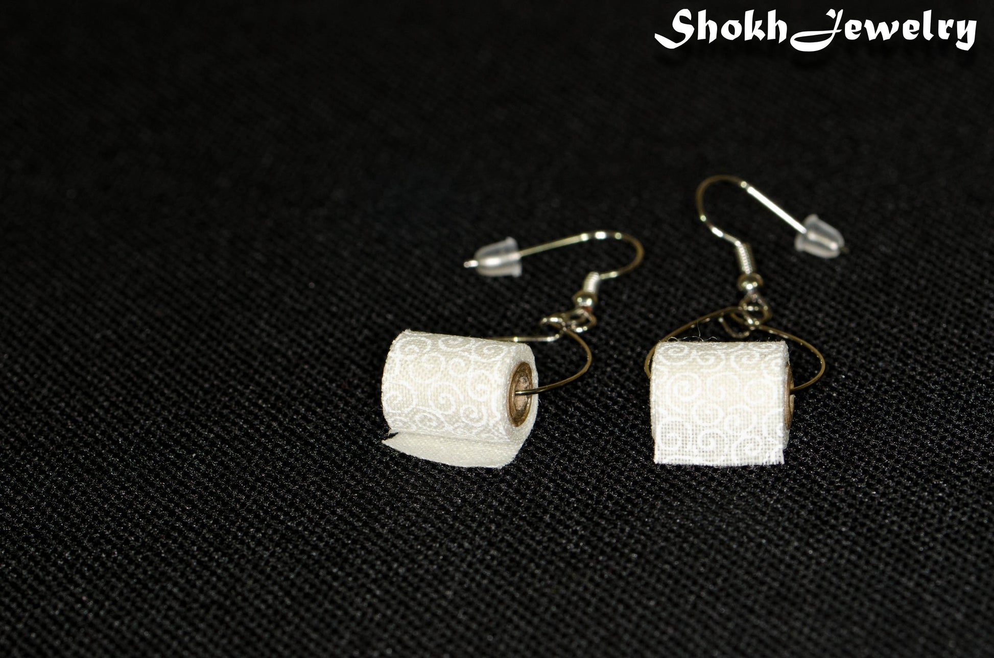 Close up of Tiny Toilet Paper Roll Earrings.