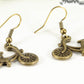 Close up of Antique Bronze Bicycle Charm Earrings.