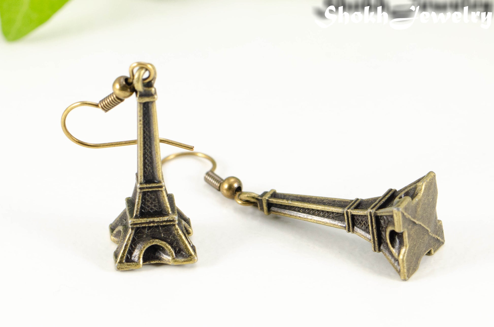 Close up of Antique Bronze 3D Eiffel Tower Charm Earrings.
