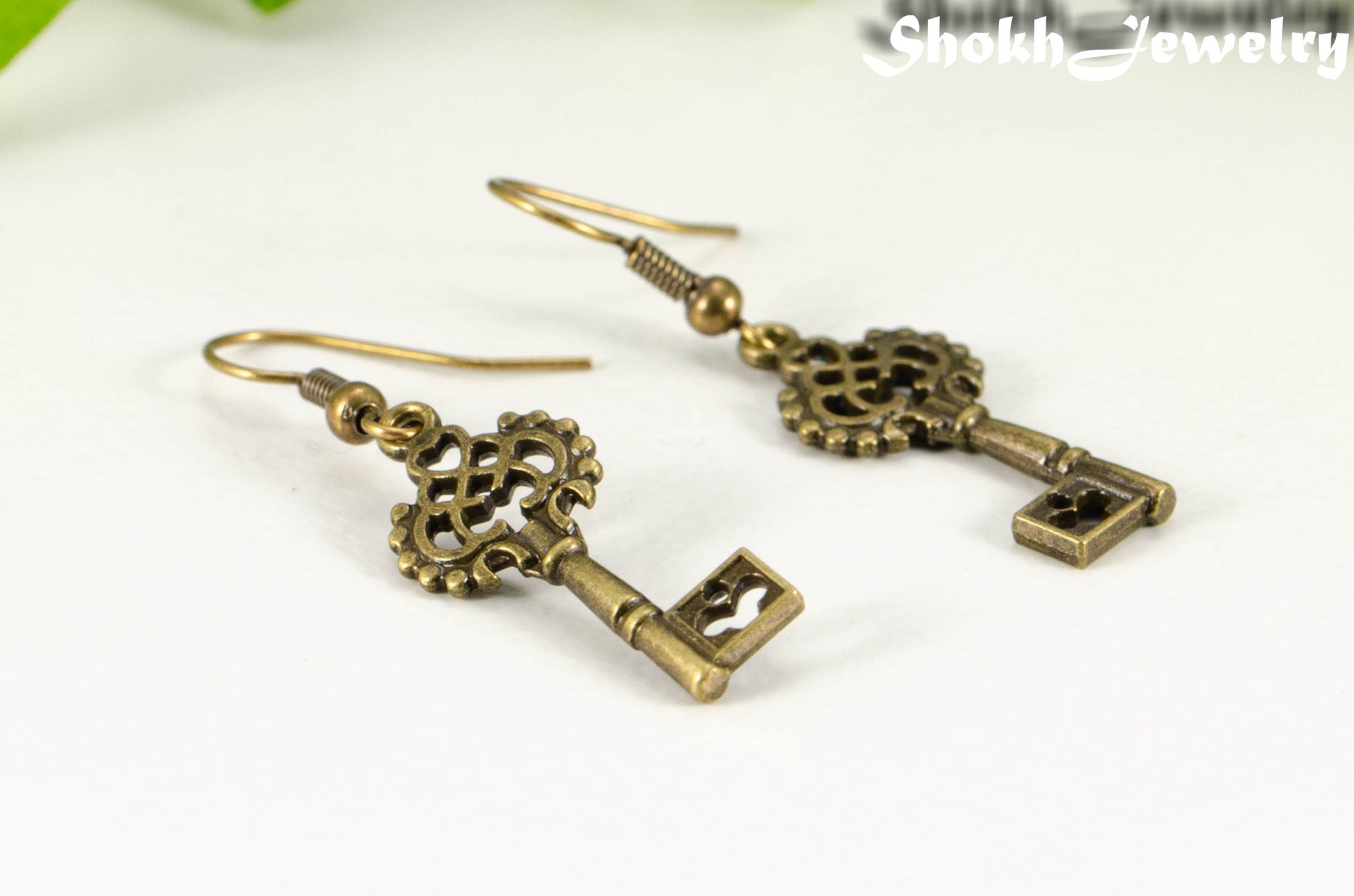 Close up of Bronze Skeleton Key Charm Earrings.