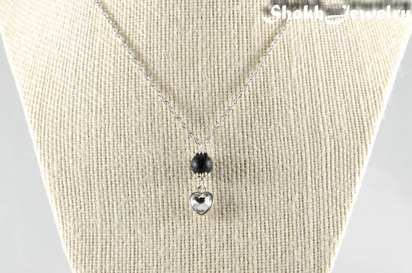 Lava Rock and Heart Shaped April Birthstone Choker Necklace displayed on a dime.