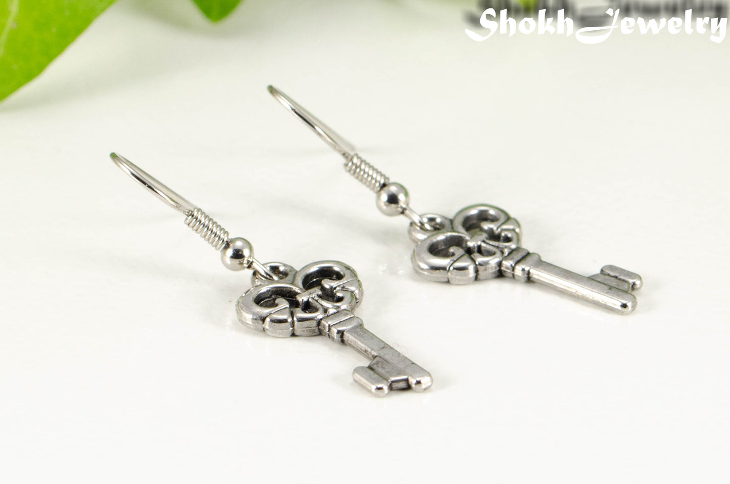 Close up of Small Skeleton Key Charm Earrings.
