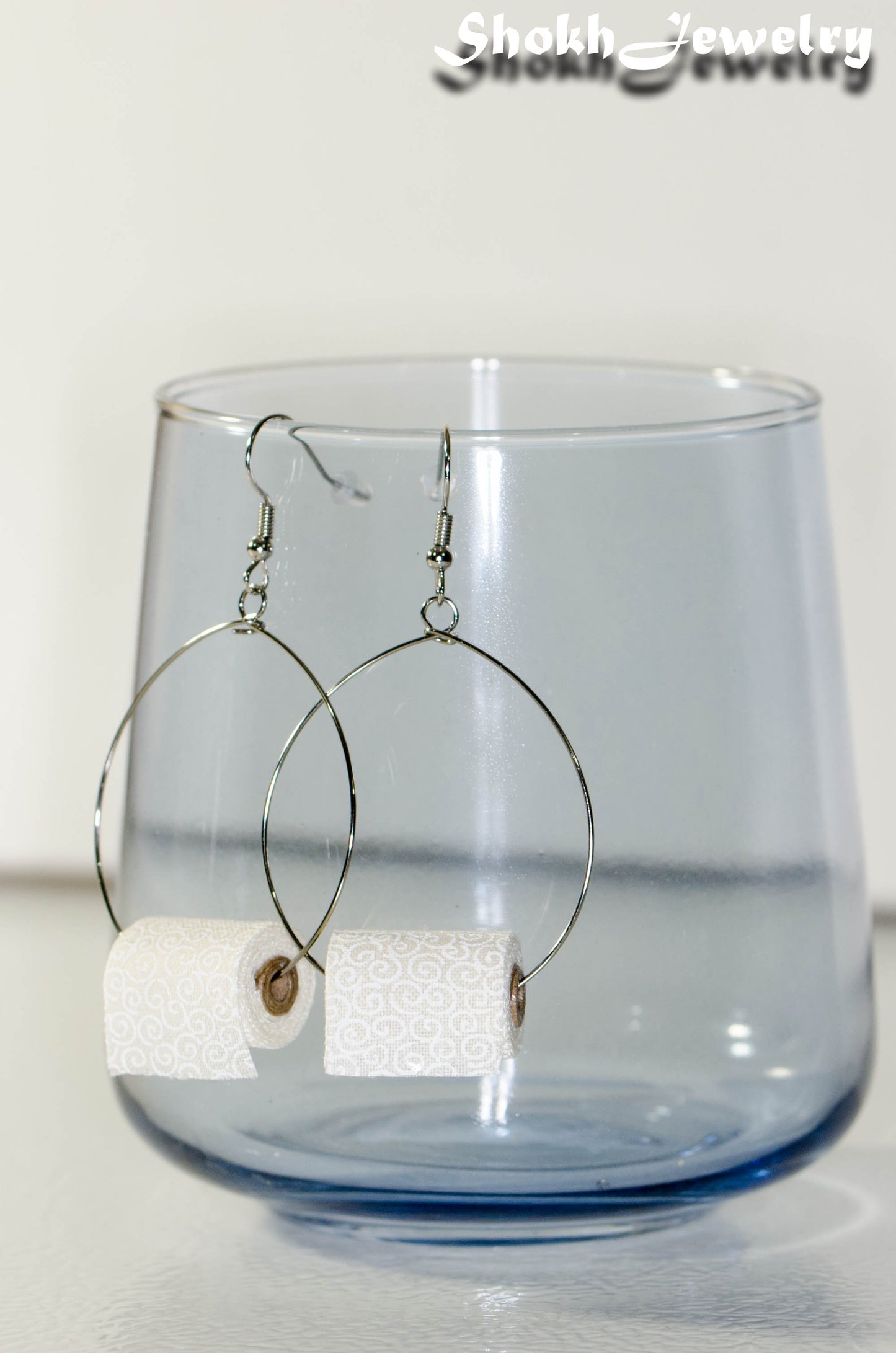 Side view of Large Miniature Toilet Paper Roll Earrings.
