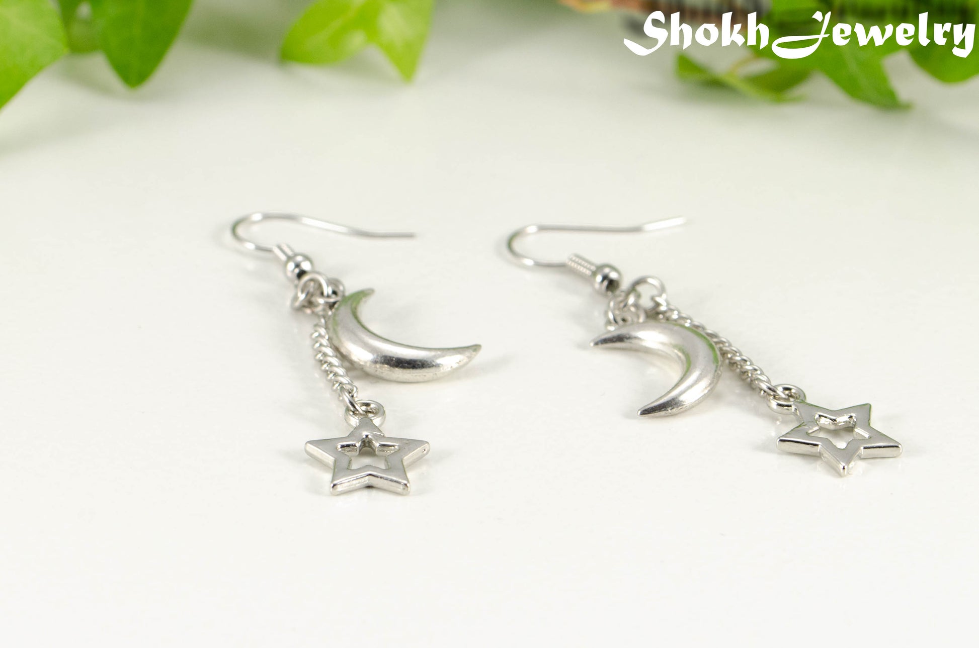 Close up of Crescent Moon and Hollow Star Earrings.