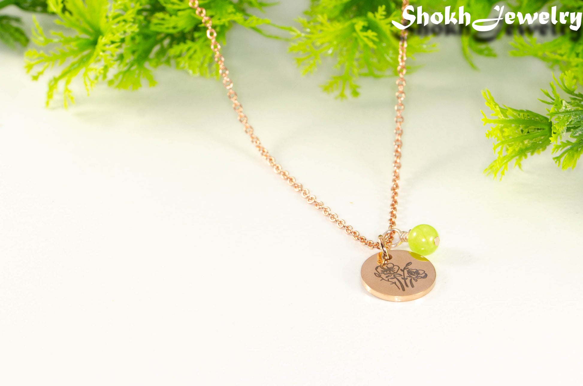Close up of Rose Gold Plated August Birth Flower Necklace with Peridot Birthstone Pendant.