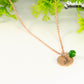 Close up of Rose Gold Plated May Birth Flower Necklace with Emerald Birthstone Pendant.