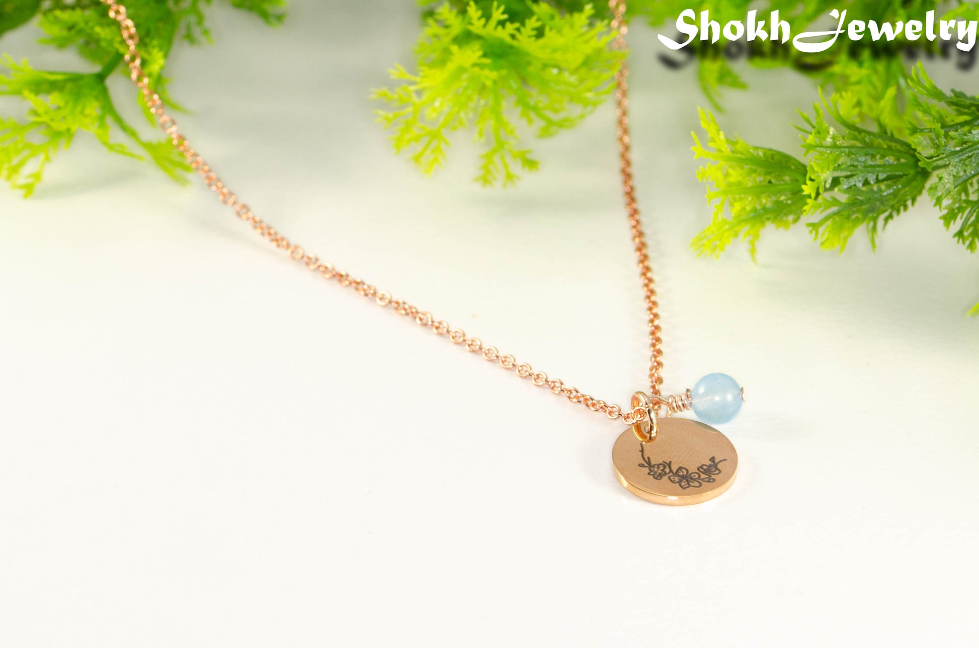 Close up of Rose Gold Plated March Birth Flower Necklace with Aquamarine Birthstone Pendant.
