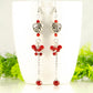 Statement Tibetan Silver Heart and Red Beaded Cluster Earrings displayed on a coffee mug.