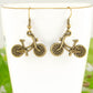 Close up of Antique Bronze Bicycle Charm Earrings.