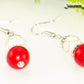 Close up of Red and White Howlite Dangle Earrings.