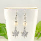 Close up of White Howlite and Tibetan Silver Maple Leaf Dangle Earrings.