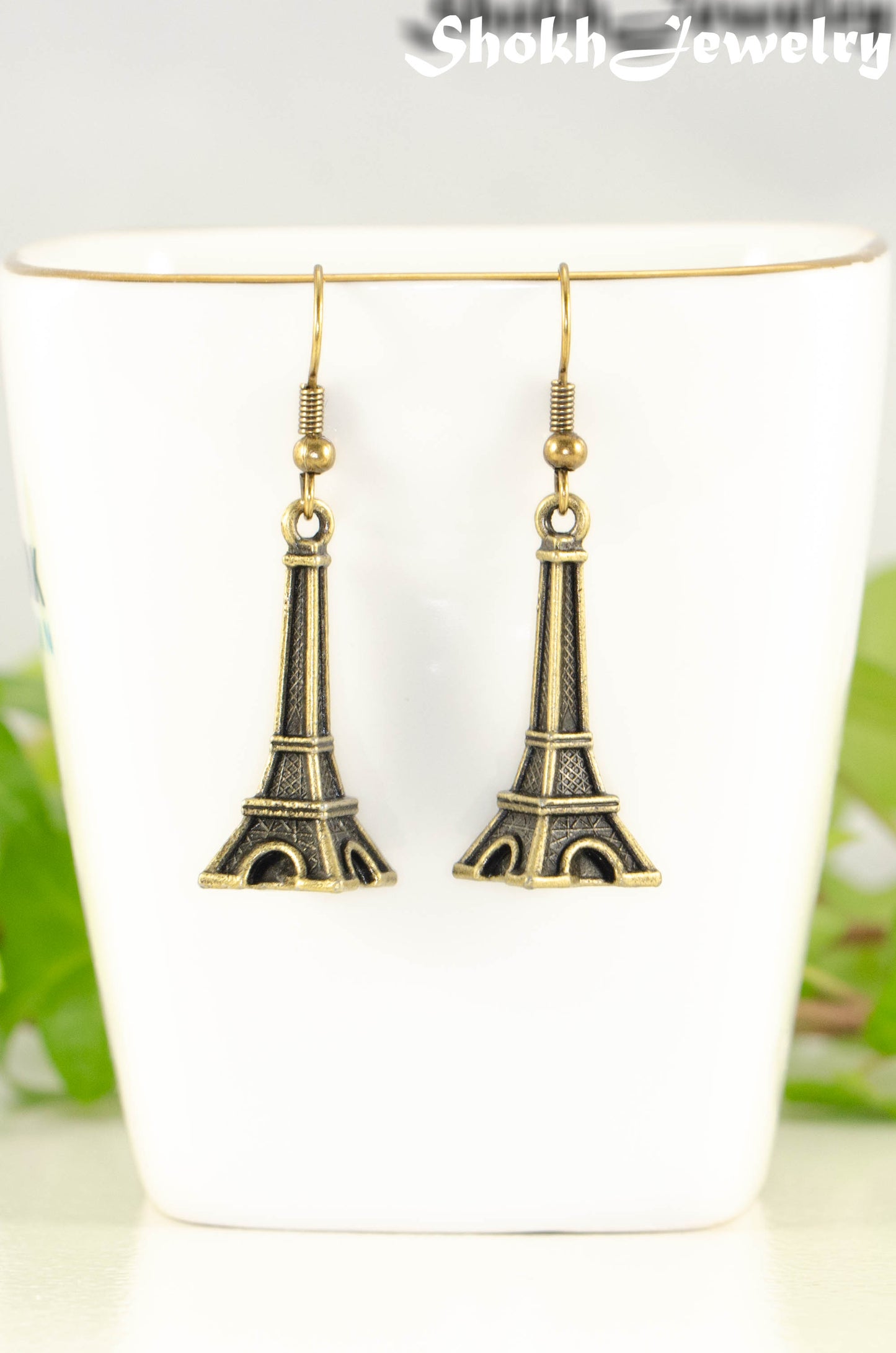 Close up of Antique Bronze 3D Eiffel Tower Charm Earrings.