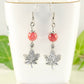 Red Quartzite and Tibetan Silver Maple Leaf Dangle Earrings displayed on tea cup.