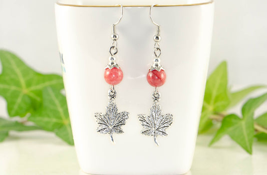 Red Quartzite and Tibetan Silver Maple Leaf Dangle Earrings displayed on tea cup.