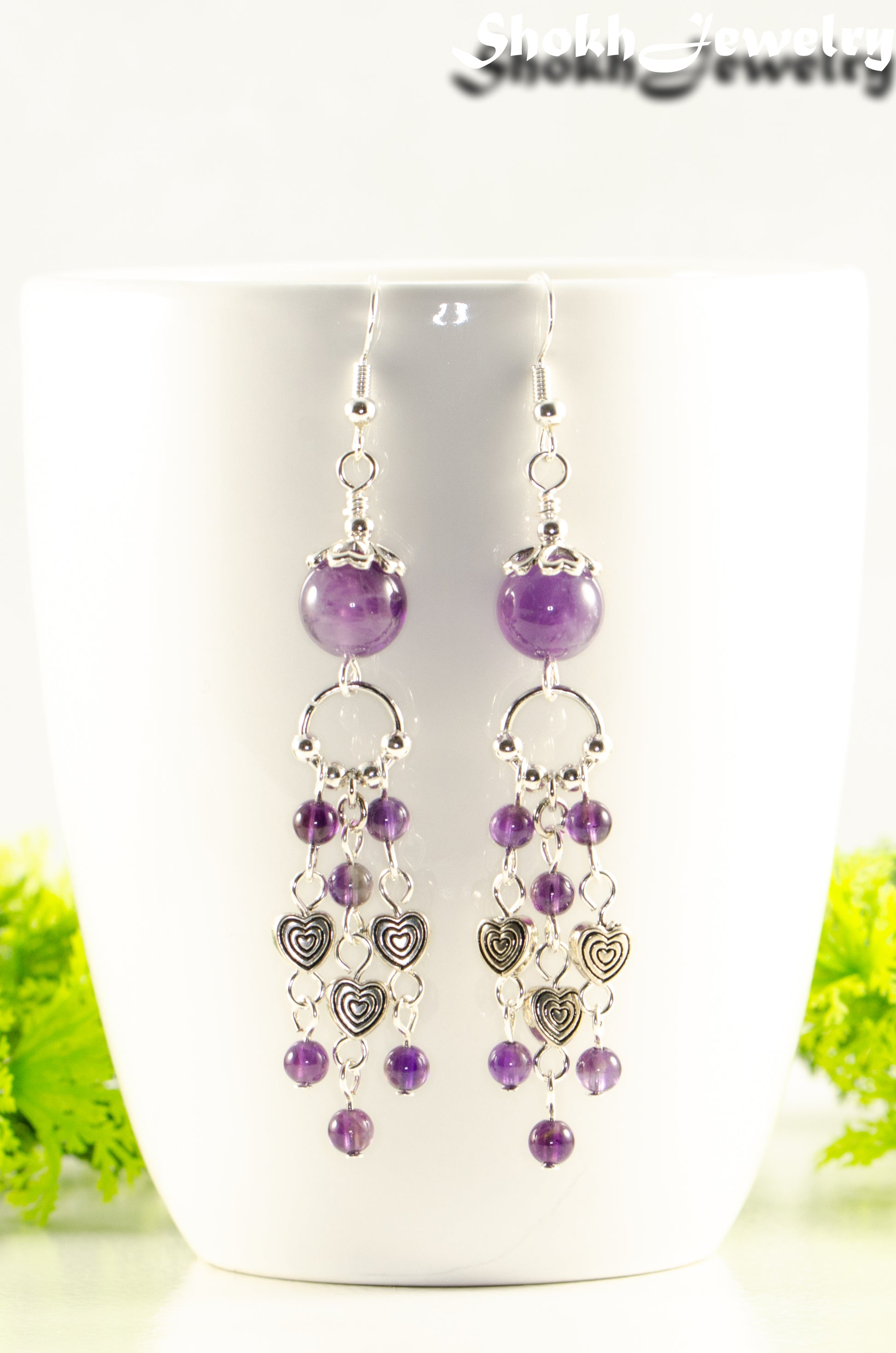 Close up of Statement Amethyst and Heart Chandelier Earrings.