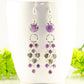 Statement Amethyst and Heart Chandelier Earrings displayed on a coffee cup.