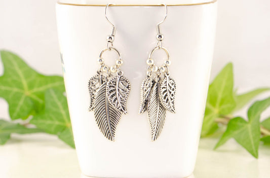 Statement Tibetan Silver Leaf Charm Earrings displayed on a tea cup.