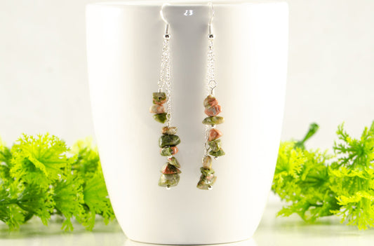 Long Silver Plated Chain and Unakite Crystal Chip Earrings displayed on a coffee mug.