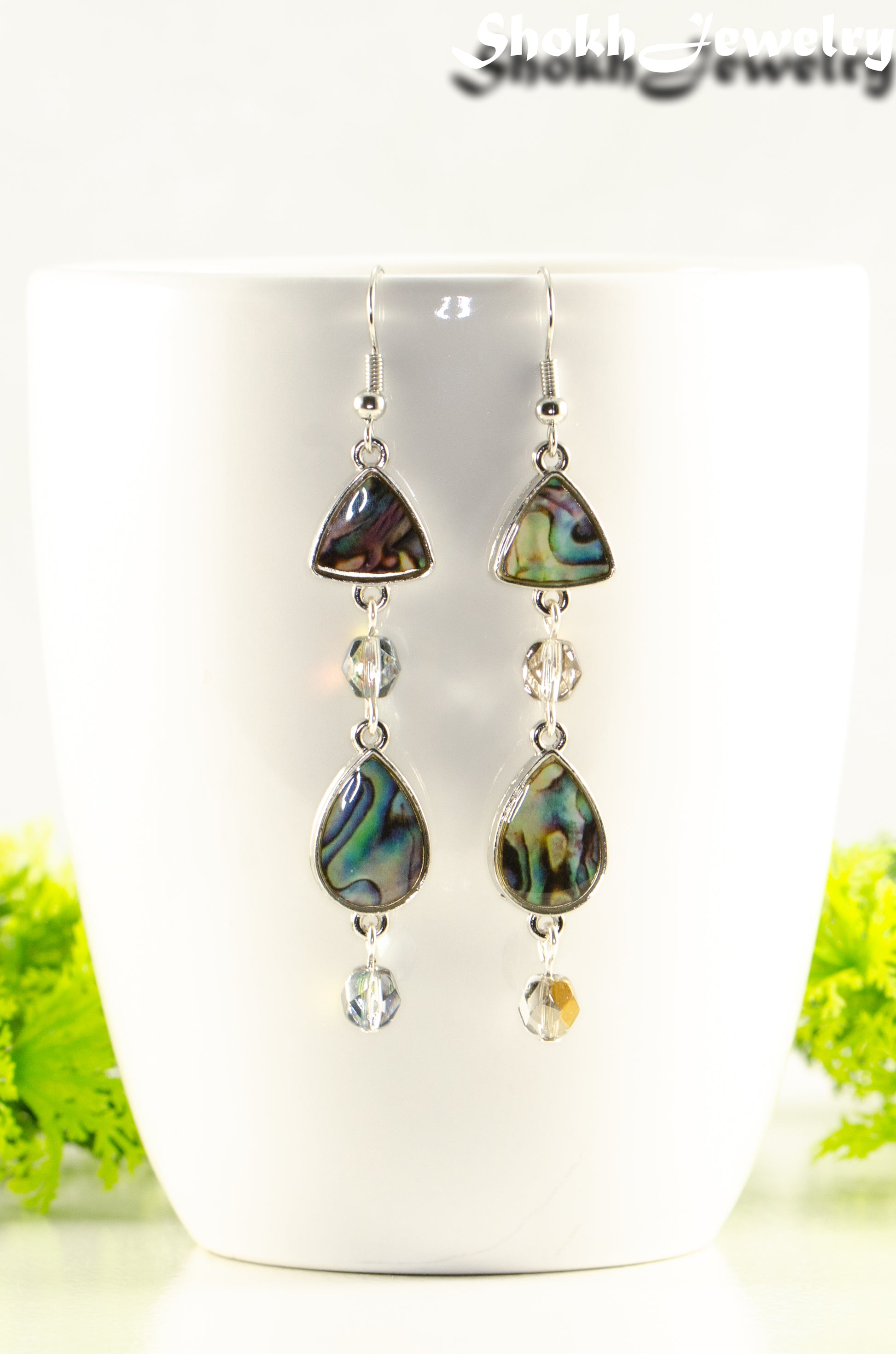 Close up of Long Abalone Shell and Glass Crystal Earrings.