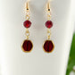 Close up of Dark Red and Gold Glass Bead Earrings.