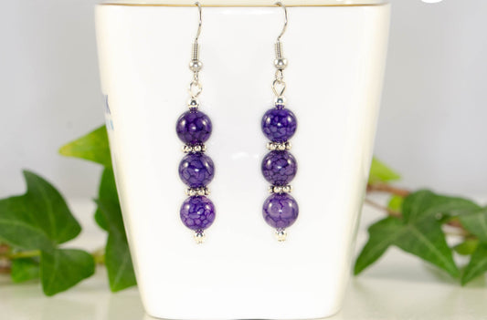 Natural Purple Dragon Vein Agate Beaded Bar Earrings displayed on a tea cup.