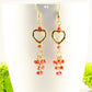 Close up of Gold Plated Heart and Red Crystal Cluster Earrings.
