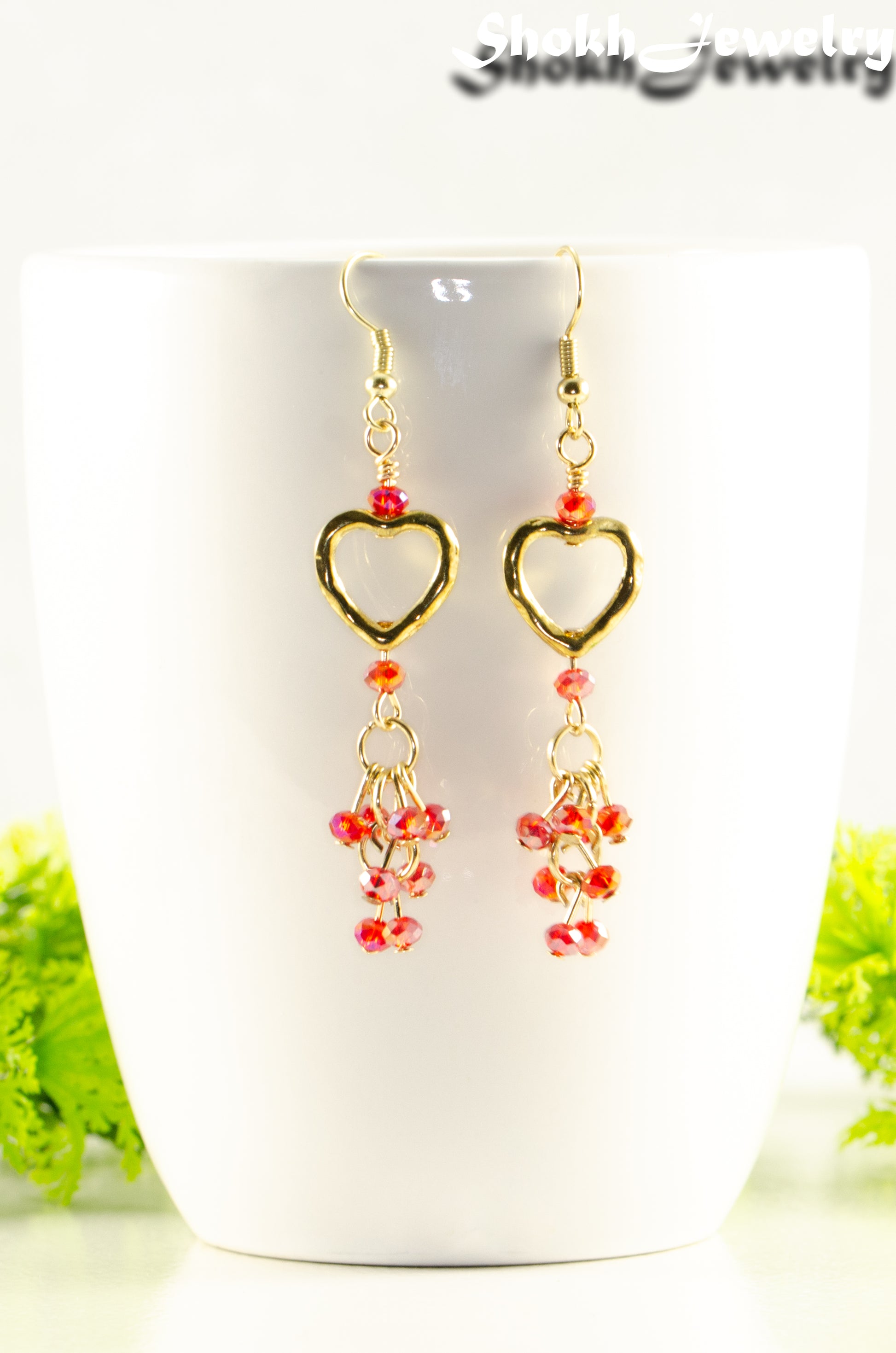 Close up of Gold Plated Heart and Red Crystal Cluster Earrings.