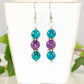 Purple Quartzite and Blue Jade Beaded Bar Earrings displayed on a tea cup.