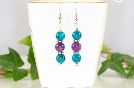 Purple Quartzite and Blue Jade Beaded Bar Earrings displayed on a tea cup.