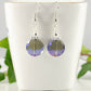 Iridescent Blue Glass Crystal Beads Earrings displayed on a tea cup.