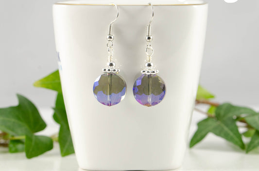 Iridescent Blue Glass Crystal Beads Earrings displayed on a tea cup.