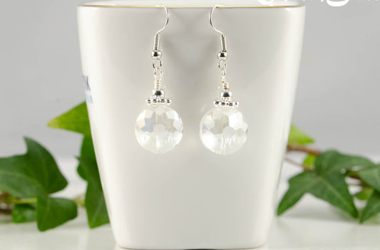 Frosted Glass Crystal Beads Earrings displayed on a tea cup.