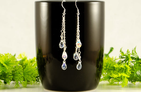 Long Silver Plated Chain and Czech Teardrop Crystal Earrings displayed on a coffee mug.