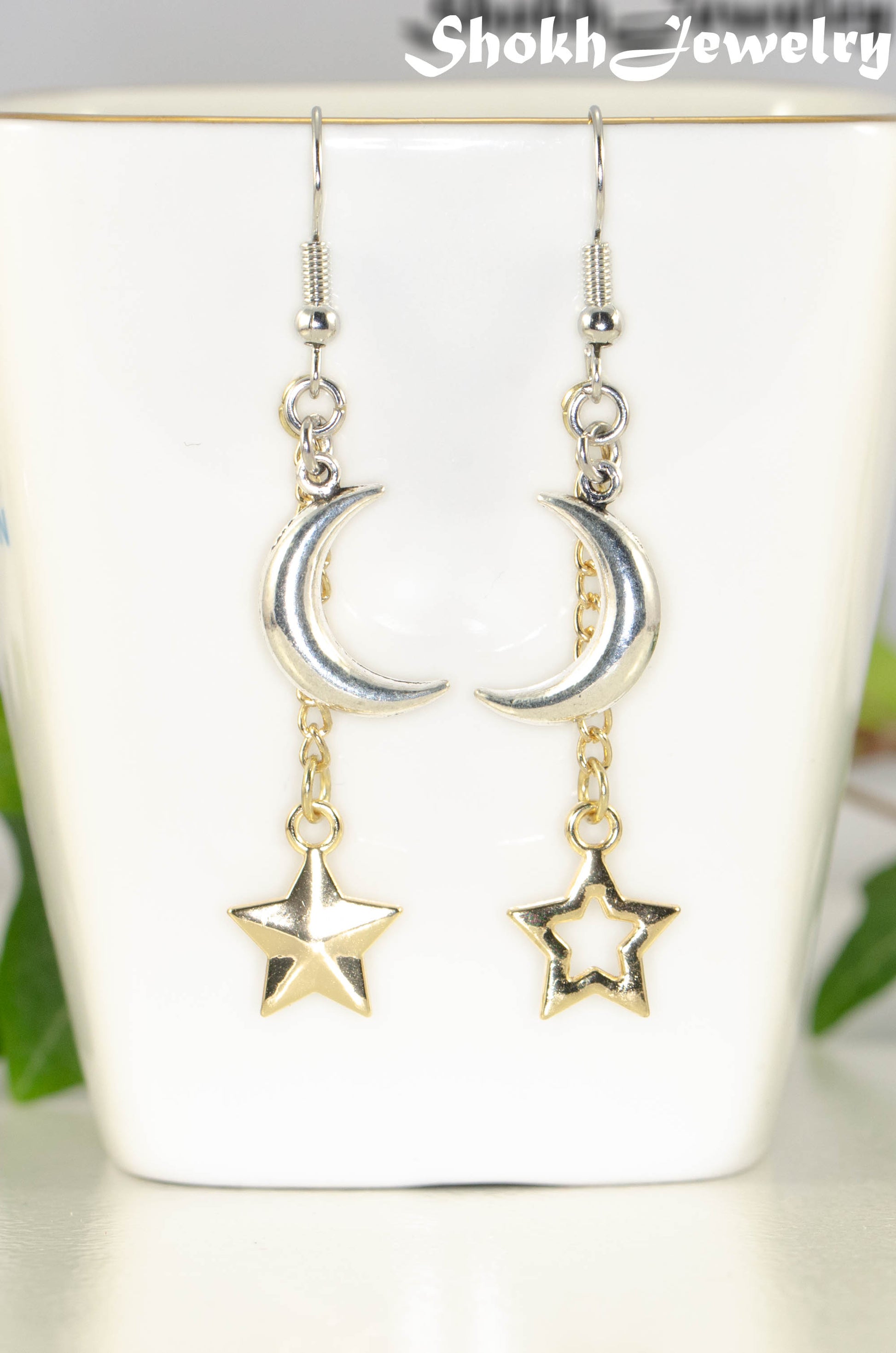 Close up of Crescent Moon and Mismatched Gold Star Earrings.
