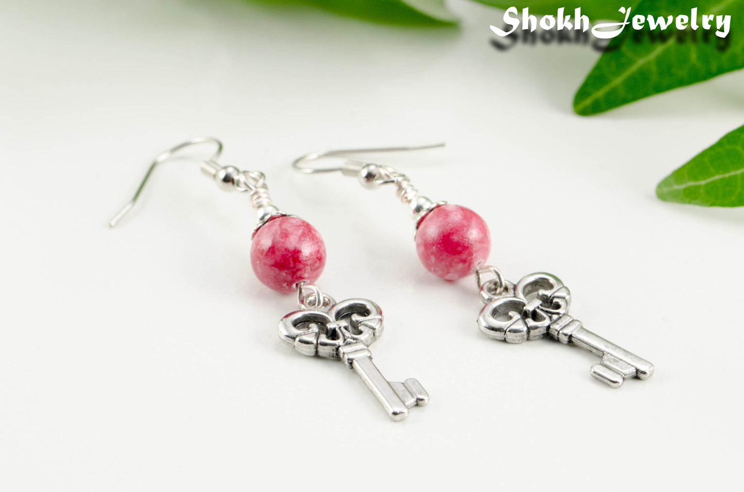 Close up of Red Quartzite and Key Charm Dangle Earrings.