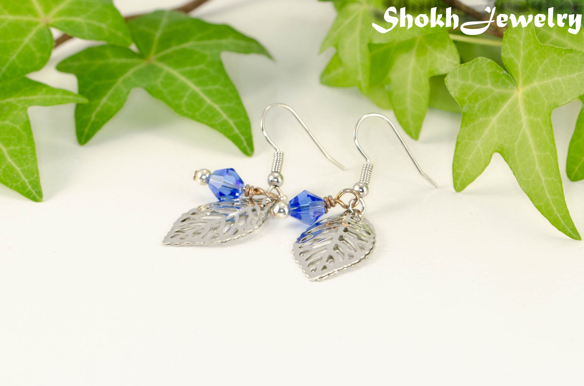 Filigree Silver Leaf Charm and Blue Glass Crystal Earrings for women.