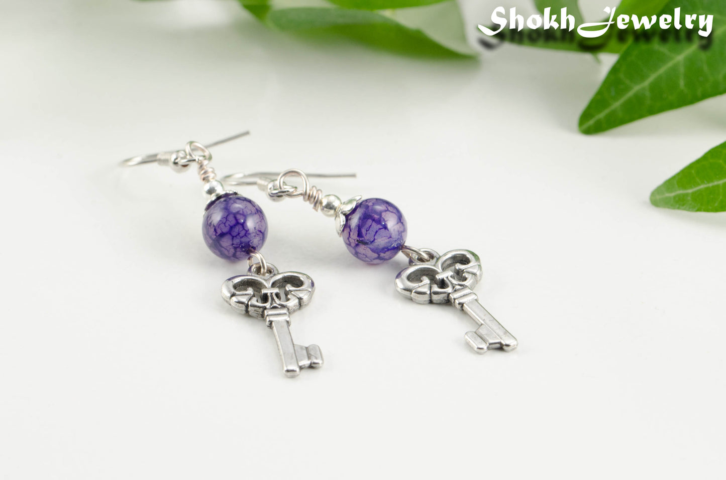 close up of Purple Agate and Key Charm Dangle Earrings.