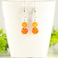 Small Natural Carnelian Earrings displayed on a tea cup.