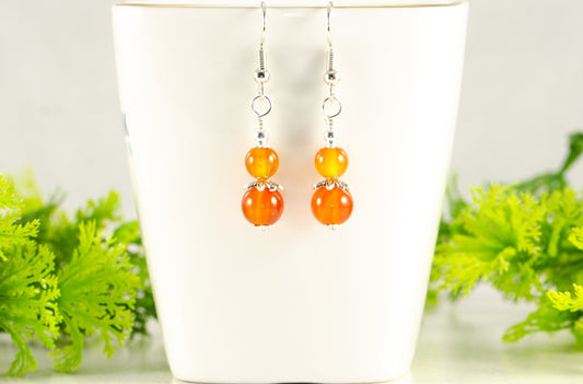 Small Natural Carnelian Earrings displayed on a tea cup.