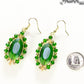 Oval Green Glass Crystal Wire Wrapped Earrings beside a dime.