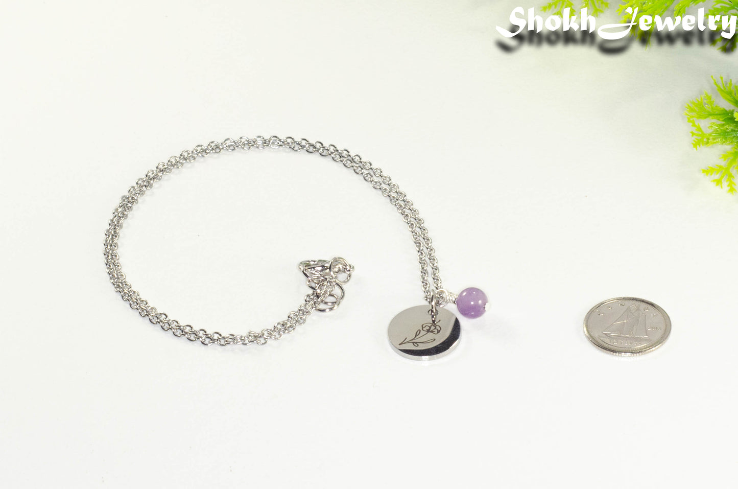 February Birth Flower Necklace with Amethyst Birthstone Pendant beside a dime.