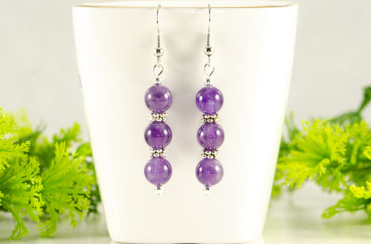 Natural Amethyst Beaded Bar Earrings displayed on a tea cup.