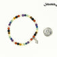 Dainty Gemstone Chakra Bracelet with Initial beside a dime.