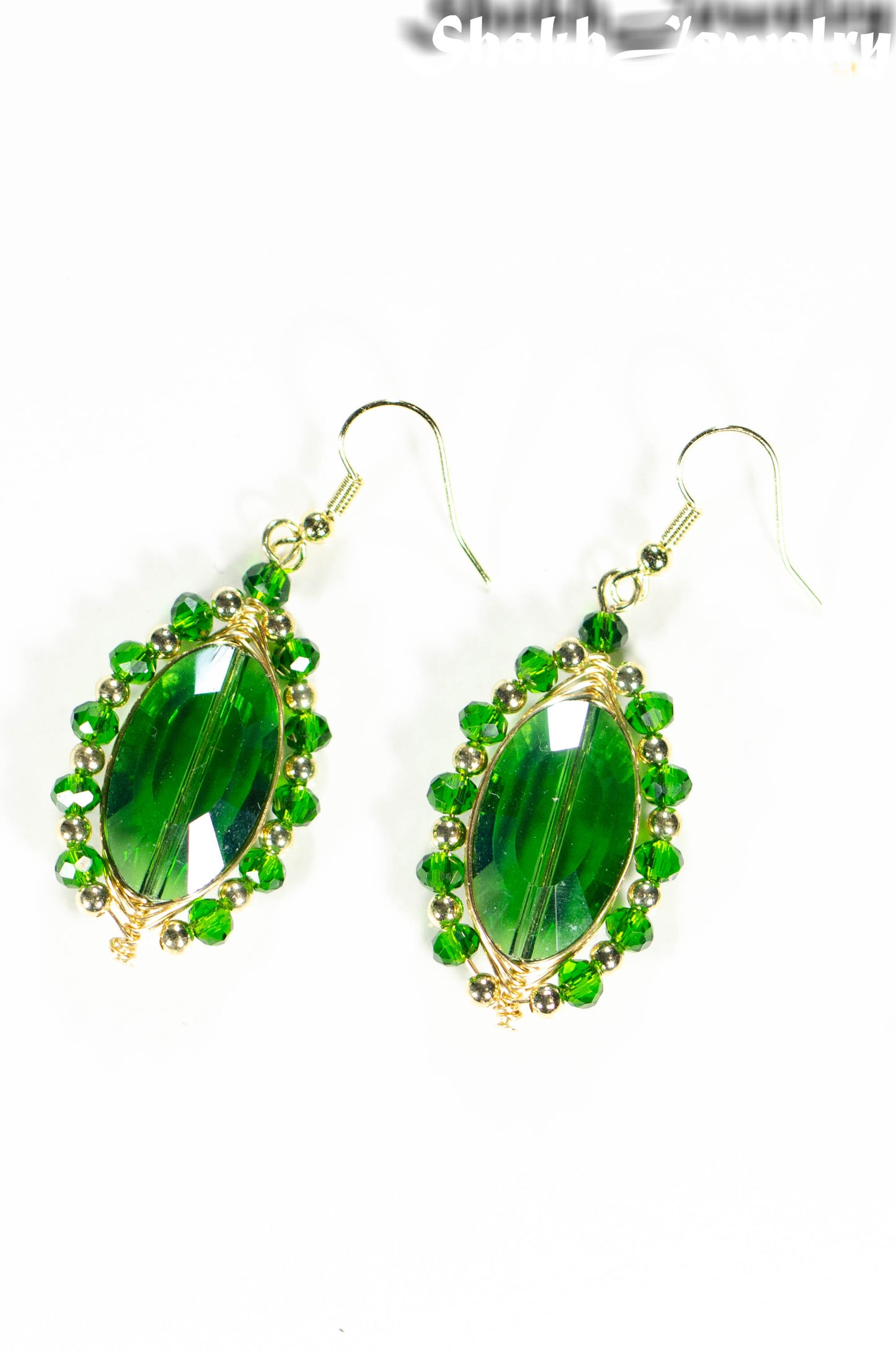 Top view of Oval Green Glass Crystal Wire Wrapped Earrings.