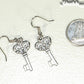 Small Skeleton Key Charm Earrings beside a dime.