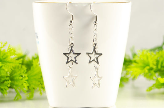Stainless steel chain and 2 star earrings displayed on a tea cup.