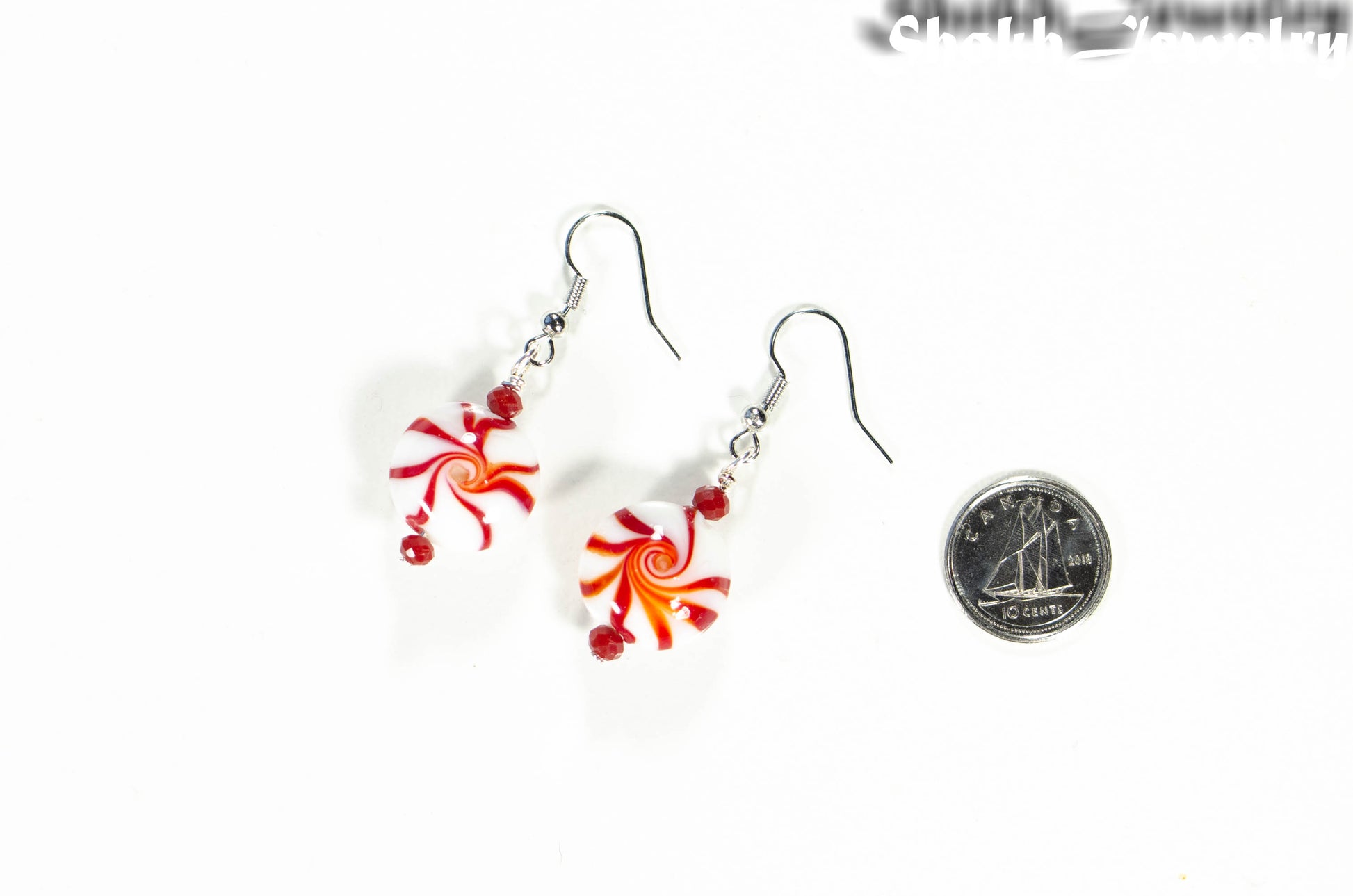 Christmas Peppermint Glass Bead Earrings beside a dime.